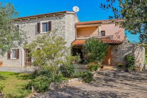 an old stone house with a garden at Villa Ana - Peaceful Location in Marčana