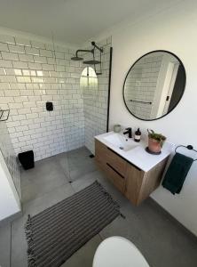 a bathroom with a sink and a mirror at Rondebosch loft in Cape Town