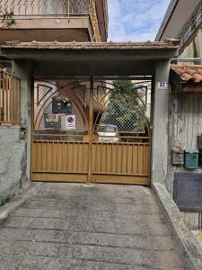 a wooden garage door with a car in it at Alle Porte Del Pigno House in Catania