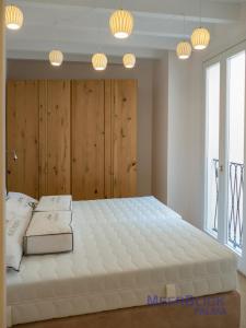 a large white bed in a room with lights at Aparttime Palma mit 3 MeerBlick Dach-Terrassen in Palma de Mallorca