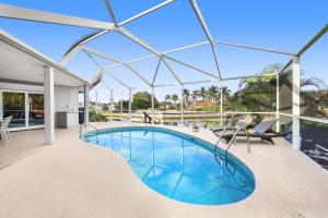 an image of a swimming pool with a glass roof at 429 North Barfield Drive in Marco Island