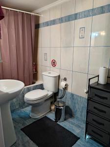 a bathroom with a toilet and a sink at OLGAS SQUARE APARTMENT CKBSM in Patra