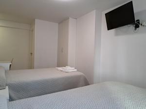 A bed or beds in a room at Pension Iruna