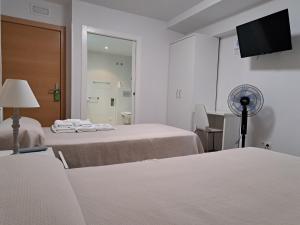A bed or beds in a room at Pension Iruna
