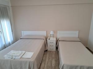 A bed or beds in a room at Pension Iruna
