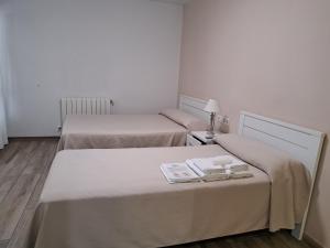 A bed or beds in a room at Pension Iruna