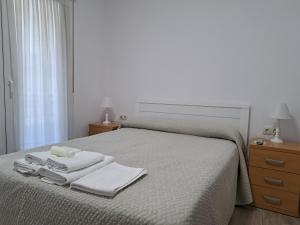 A bed or beds in a room at Pension Iruna