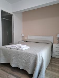 A bed or beds in a room at Pension Iruna