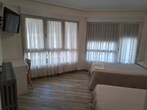 A bed or beds in a room at Pension Iruna