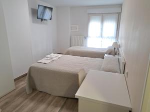 A bed or beds in a room at Pension Iruna