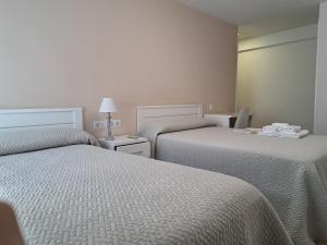 A bed or beds in a room at Pension Iruna