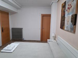 A bed or beds in a room at Pension Iruna