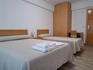 A bed or beds in a room at Pension Iruna