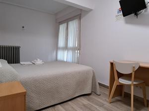 A bed or beds in a room at Pension Iruna