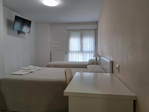 A bed or beds in a room at Pension Iruna