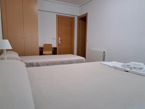 A bed or beds in a room at Pension Iruna