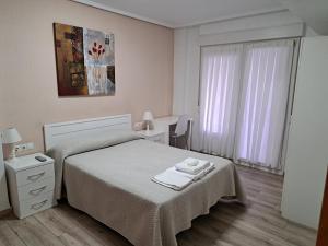 A bed or beds in a room at Pension Iruna
