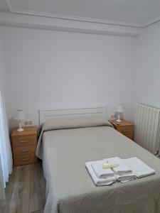 A bed or beds in a room at Pension Iruna