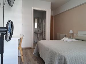 A bed or beds in a room at Pension Iruna