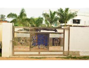 a building with a gate with graffiti on it at Eeshwar Lodge, Patnagarh, Odisha 