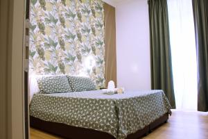 a bedroom with a bed with a floral wallpaper at Hotel Ciao in Rome