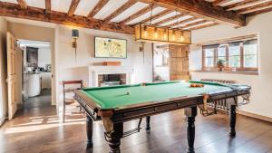 a living room with a pool table in it at Beaufort Farmhouse in Grosmont