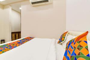 a bedroom with a bed with a colorful comforter at FabHotel Prime Kingfisher in Udaipur