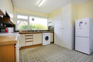 a kitchen with a white refrigerator and a dishwasher at BOURNECOAST - BUNGALOW by HENGISTBURY HEAD and SANDY BEACHES - HB5830 in Southbourne +42 photos