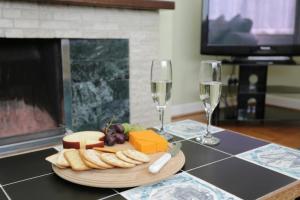 a table with a plate of cheese and two glasses of wine at BOURNECOAST - BUNGALOW by HENGISTBURY HEAD and SANDY BEACHES - HB5830 in Southbourne