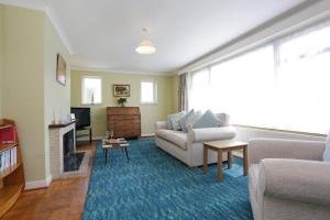 a living room with a couch and a fireplace at BOURNECOAST - BUNGALOW by HENGISTBURY HEAD and SANDY BEACHES - HB5830 in Southbourne