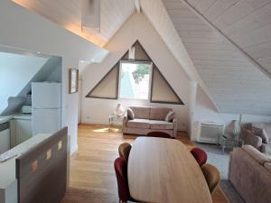 a living room with a table and a couch at Le Churchill Hôtel & Spa in Carnac