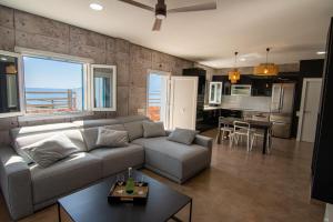 a living room with a couch and a table and a kitchen at Villa Alex in La Isleta del Moro