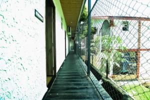 a hallway of a building with a fence at FabHotel Bay Boutique By Foxtale in Marmagao