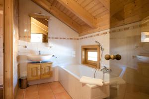 y baño con bañera y lavamanos. en Holiday home in Stefan in the Lavanttal with balcony en Elsenbrunn