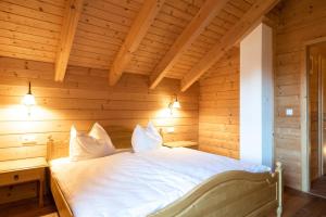 a bedroom with a bed in a wooden room at Holiday home in Stefan in the Lavanttal with balcony in Elsenbrunn