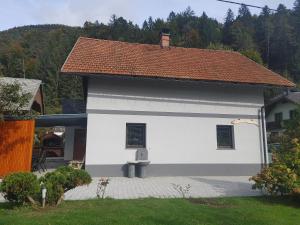 a white building with a red roof at Apartma Katja in Mojstrana
