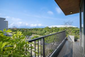 a balcony with a view of the city at The Sense Apartment - Modern, Near My An Beach in Da Nang
