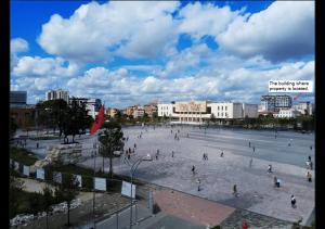 een groep mensen die rondlopen op een groot plein in een stad bij Center View Luxury Apartment in Tirana