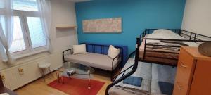 a small room with two bunk beds and a chair at Blue apartment in City Center, Best location in Bratislava