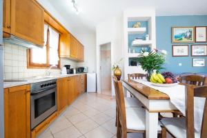 a kitchen with a table with a bowl of fruit on it at Villa Marilia in Astérion
