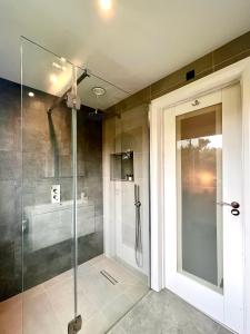 a shower with a glass door in a bathroom at The Annex, Escape to the Country in Salcombe