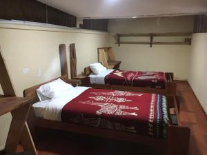 two beds in a room with two beds sidx sidx sidx at CASA IDEAL in Riobamba