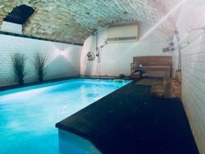uma grande piscina num quarto com em Maison piscine centre historique de Romainville em Romainville