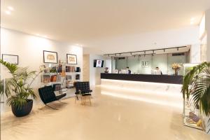 a salon with two chairs and a counter in a room at Hotel Excelsior Bari in Bari