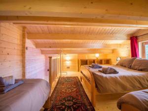a bedroom with two beds in a log cabin at Nordic Lodge in Peisey-Nancroix