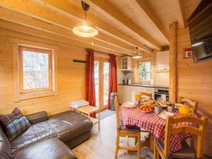 a living room with a couch and a table in a cabin at Nordic Lodge in Peisey-Nancroix