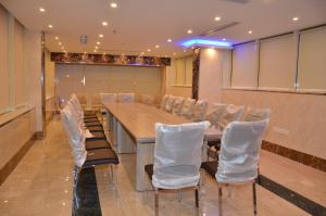 una sala de conferencias con una mesa larga y sillas en جولدن أرمادا جيزان Golden Armada Hotel, en Jazan
