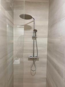 a shower with a glass door in a bathroom at Maison de Campagne avec Piscine, Vallée de la Loire in Sarcé
