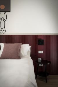 una camera con un letto bianco e un tavolino di Mitico Hotel & Natural Spa a Bologna