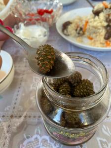 a spoonful of food in a jar on a table at Handicraft house in Karakol